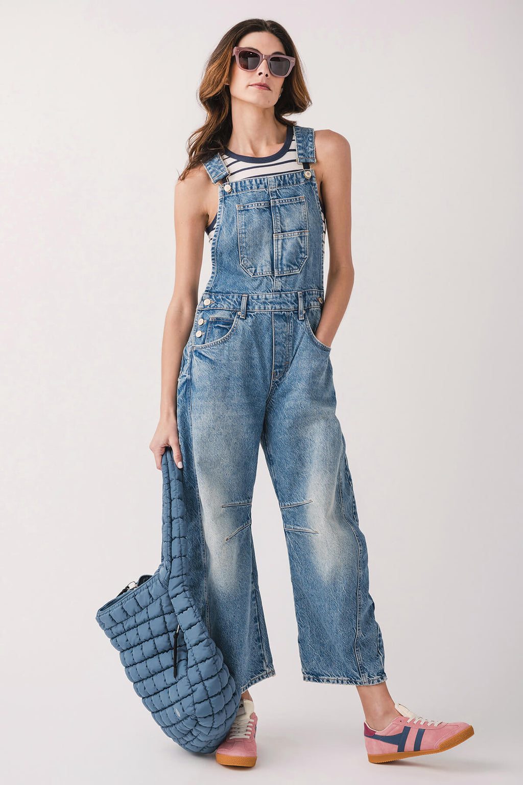 Light blue denim overalls with front bib pockets, wide-leg fit and rolled hem.
