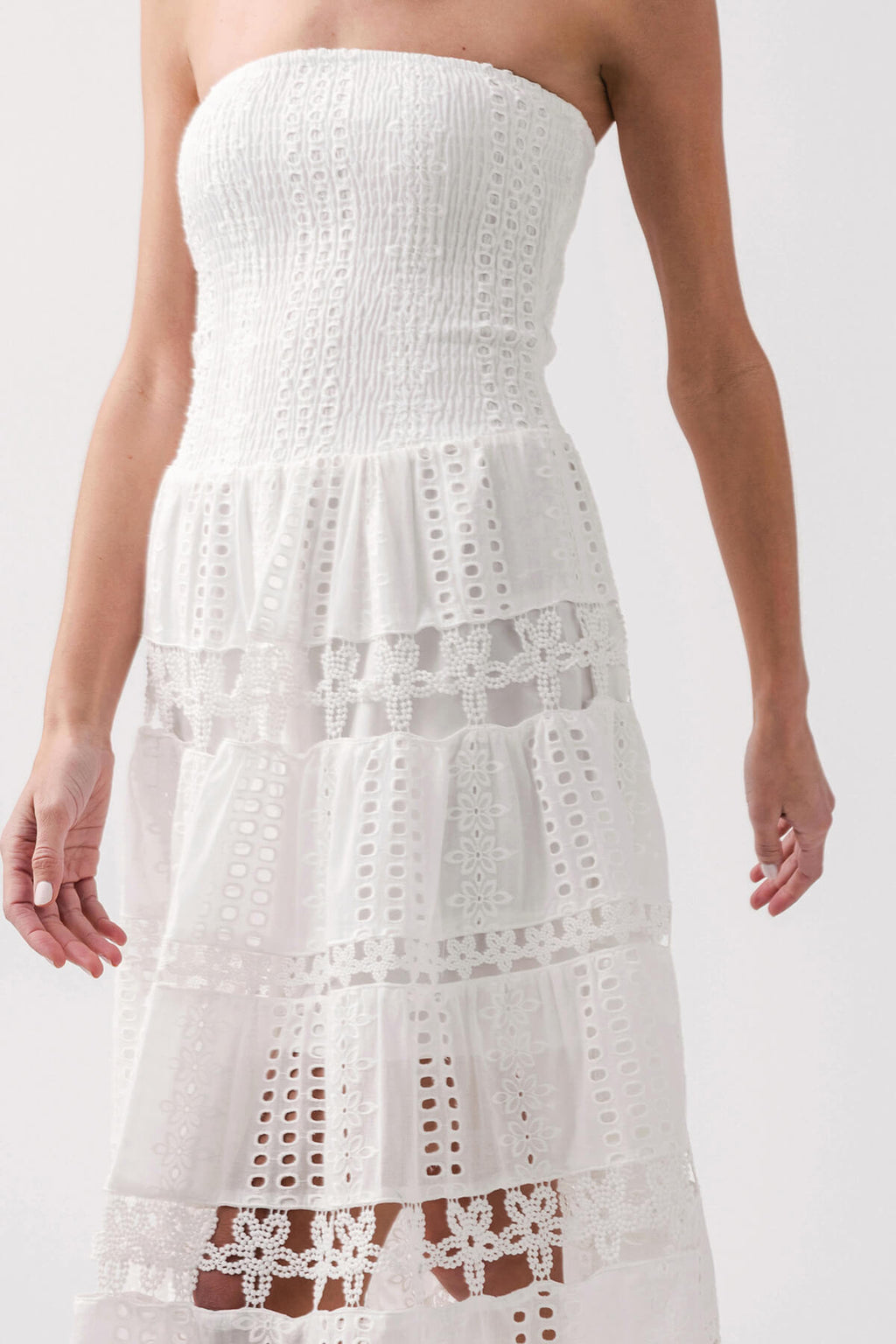 White strapless tube dress bodice with textured eyelet lace and tiered skirt
