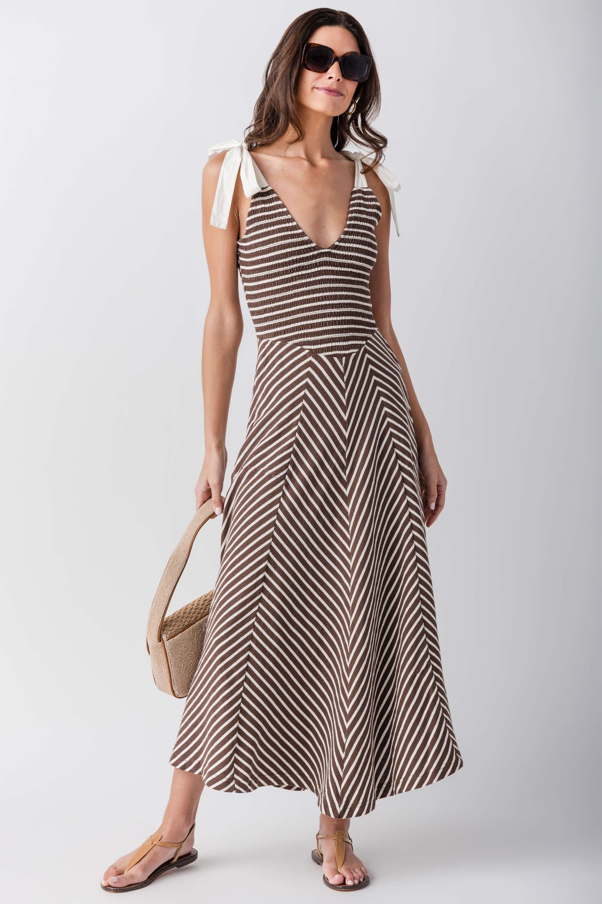 Sleeveless V-neck midi dress with cream-and-dark brown striped pattern and flared skirt