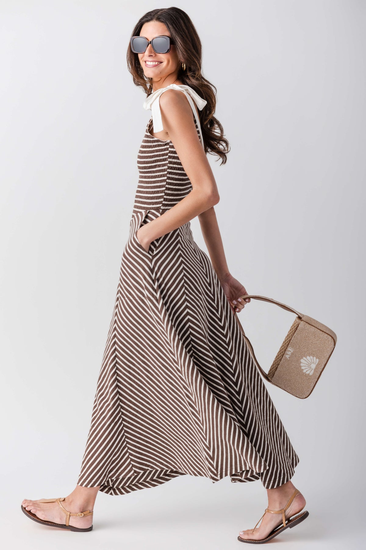 Sleeveless V-neck striped midi dress with flared skirt and chevron-pattern waist panel