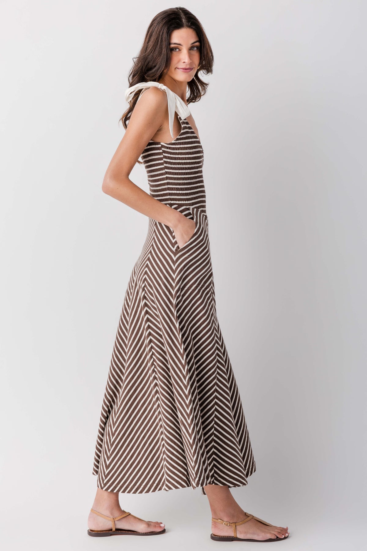Sleeveless V-neck striped midi dress with flared skirt, angled side view