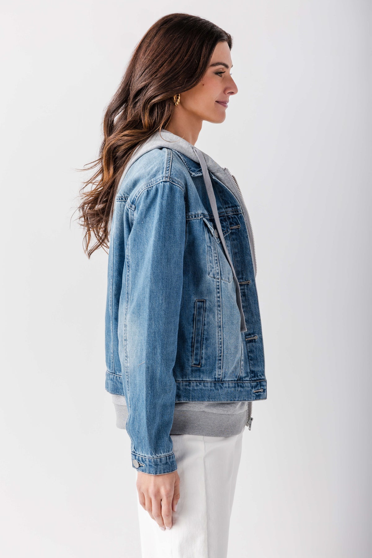 Blue denim sweatshirt jacket with hood and chest pockets, side profile