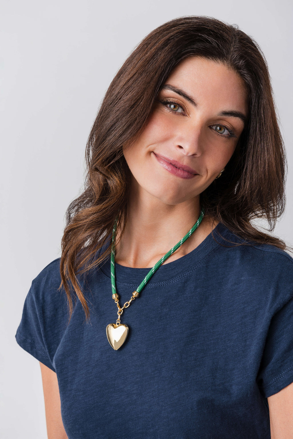 Green cord necklace with gold heart pendant
