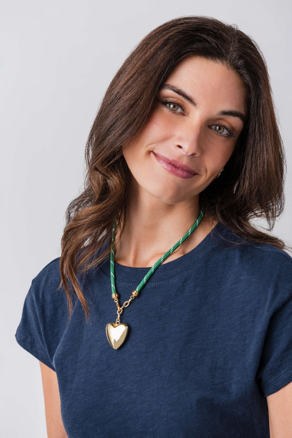 Green cord necklace with gold heart pendant