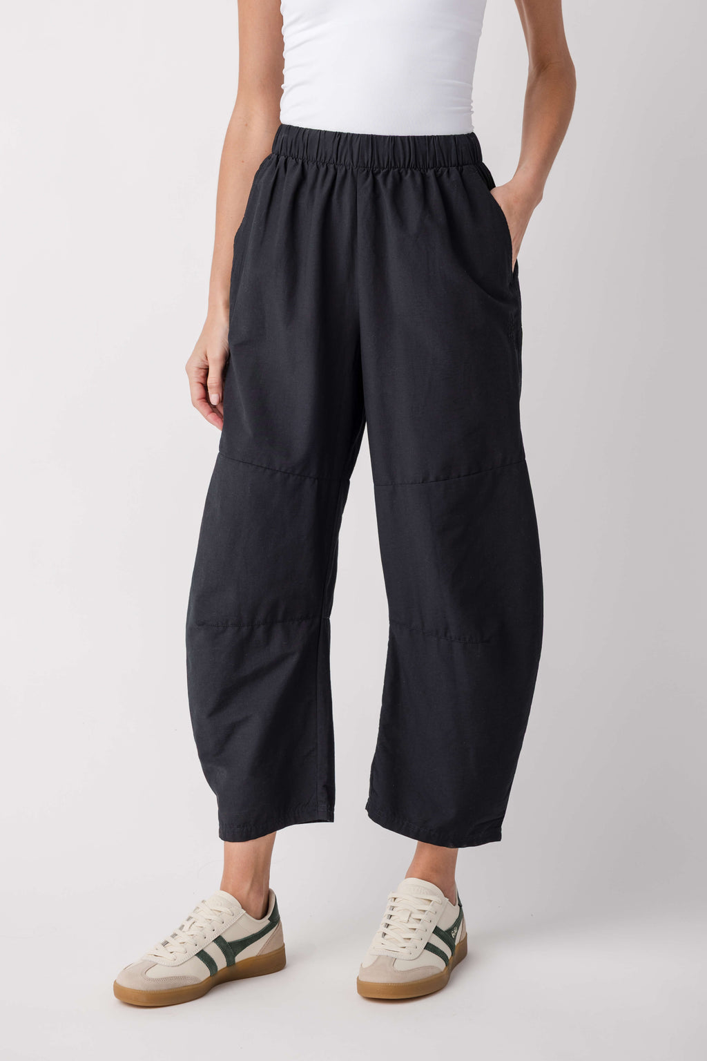 Black relaxed cropped pants with elastic waistband and cargo-style side pockets.