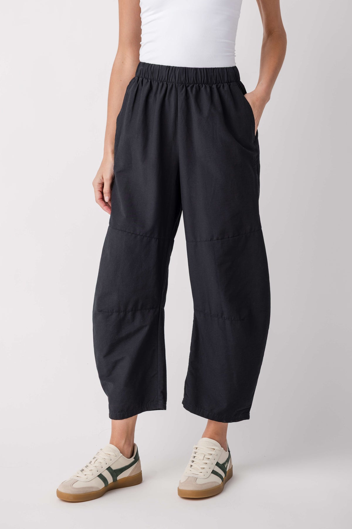Black relaxed cropped pants with elastic waistband and cargo-style side pockets.