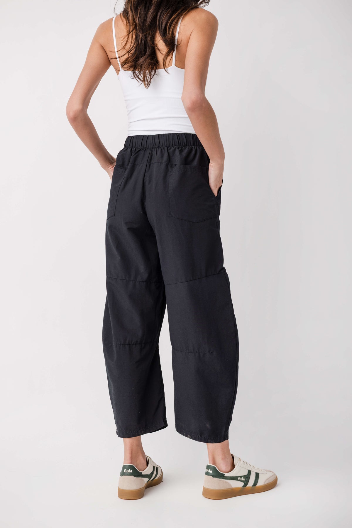 Black cropped pants with elastic waistband and panel seams on the legs.