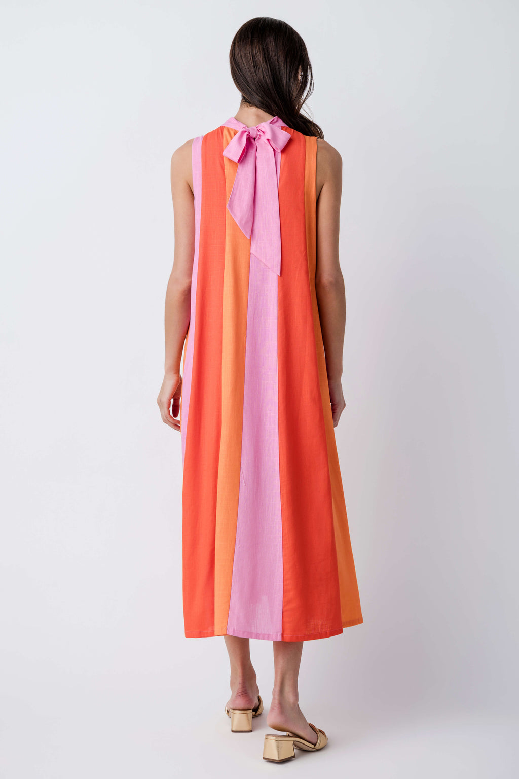 Back of sleeveless colorblock midi dress with pink tie detail and vertical stripe panels.