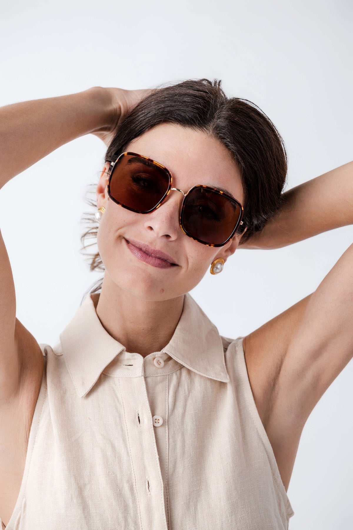 Brown octagonal sunglasses on model with amber tinted lenses
