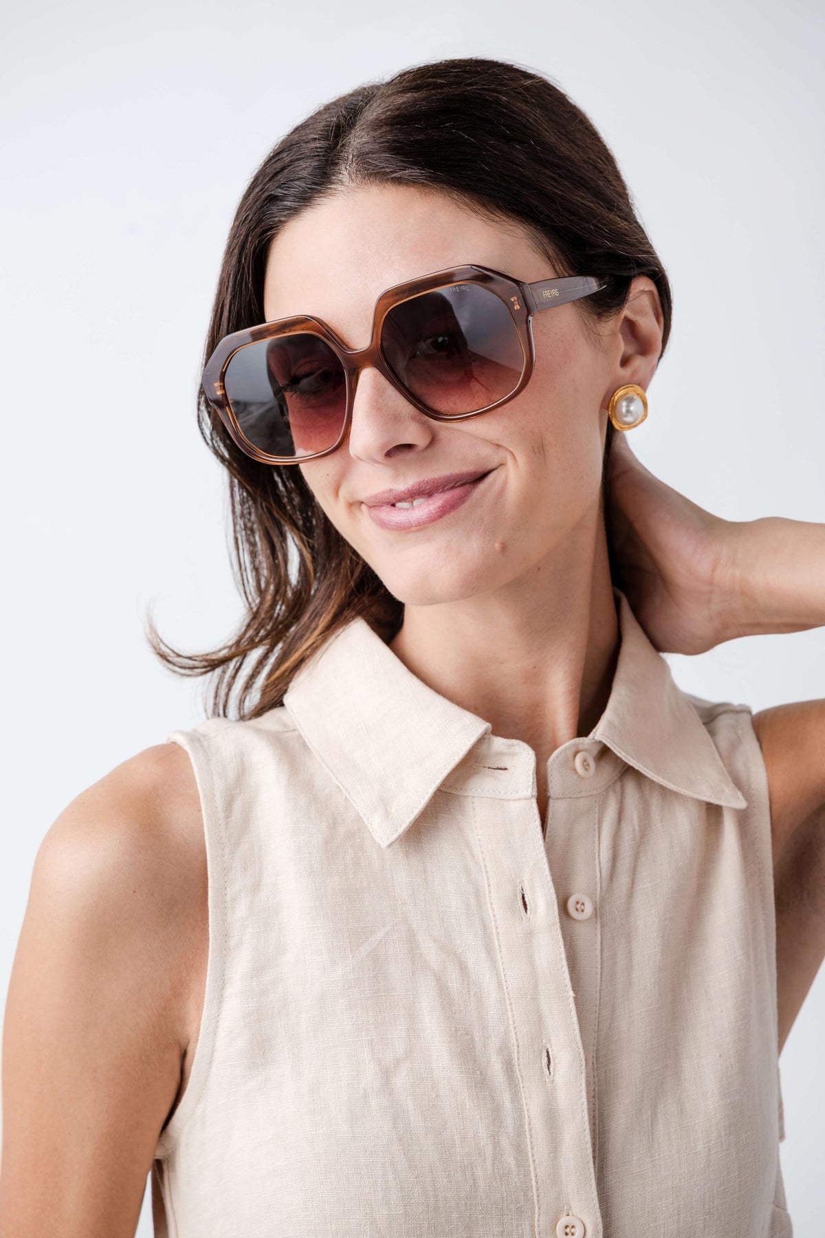Brown octagonal sunglasses with dark amber lenses worn by model