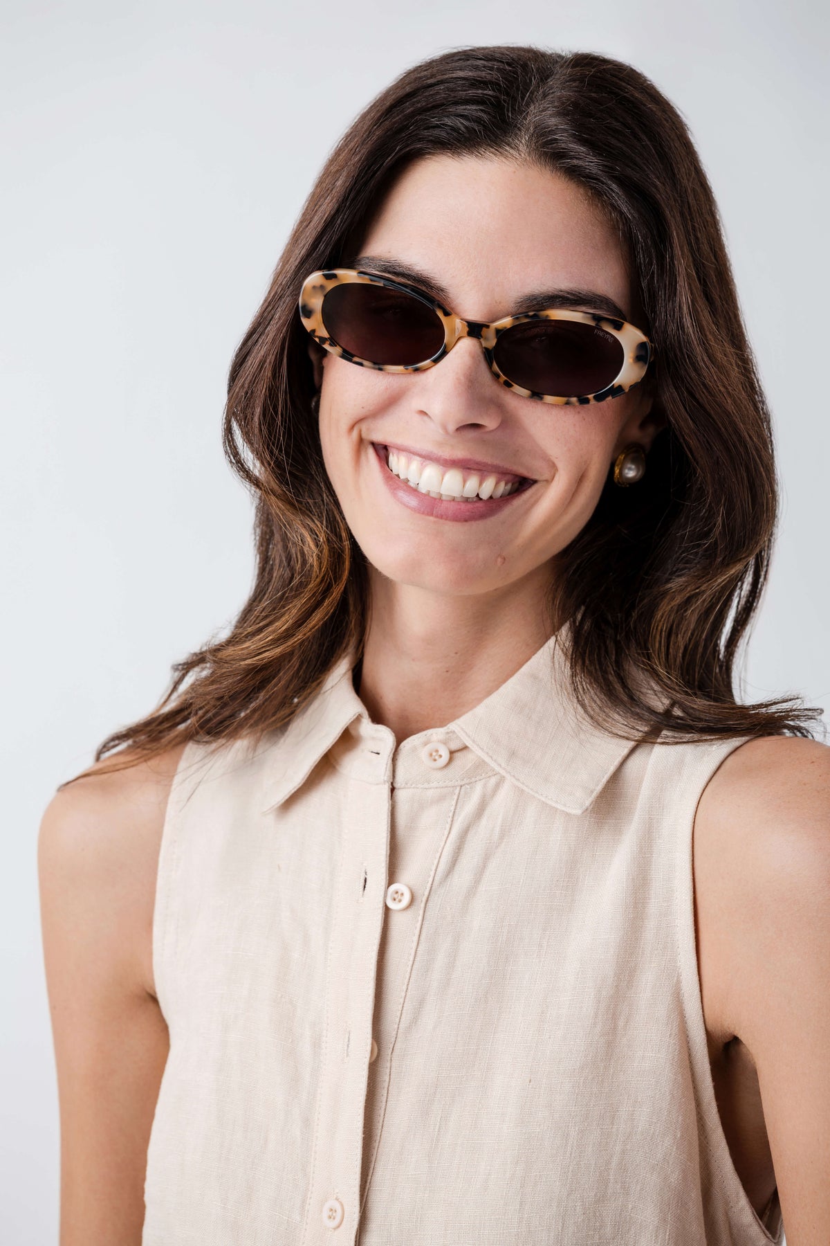 Oval tortoiseshell sunglasses with dark lenses, full front view