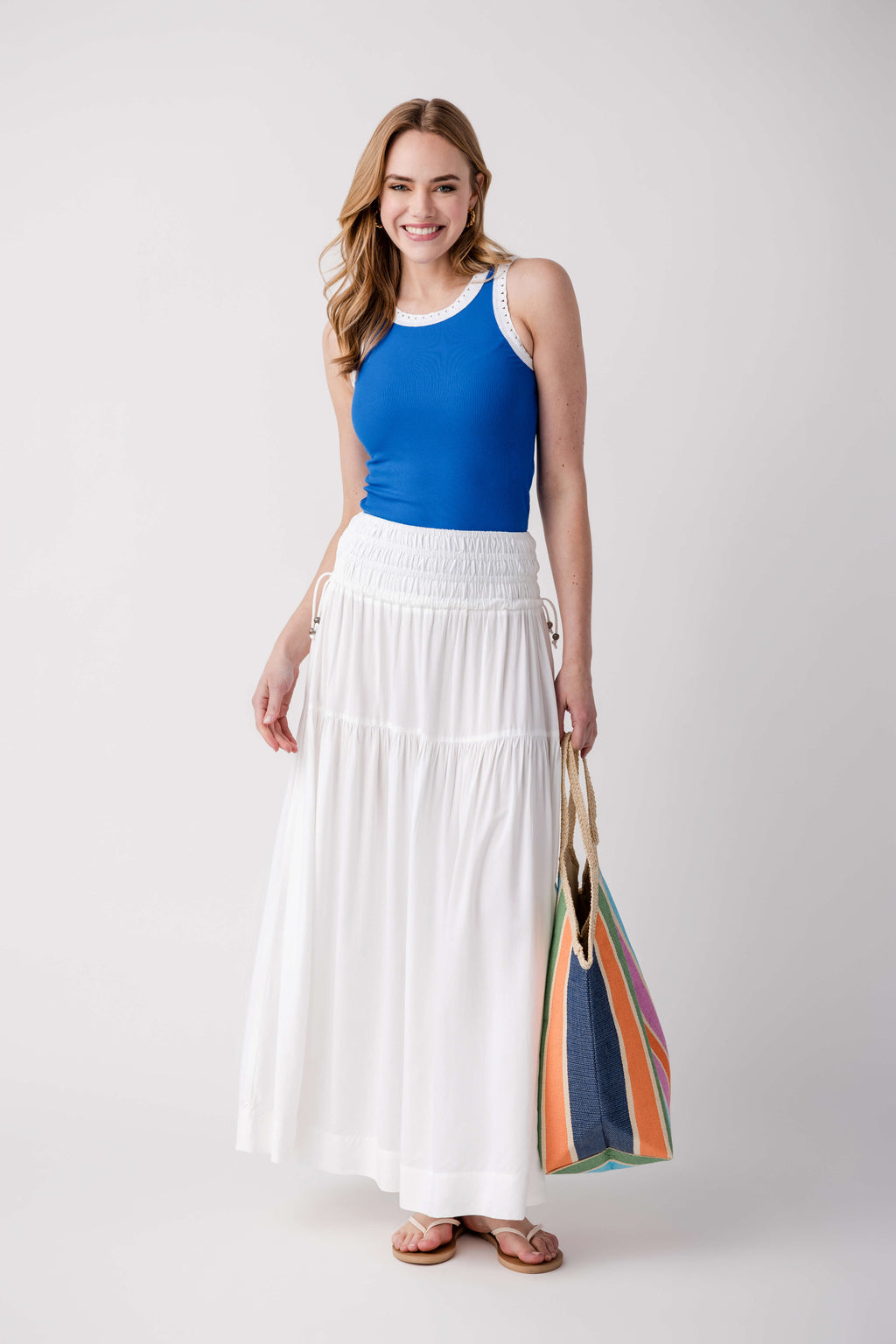 Blue sleeveless ribbed tank with scoop neck and eyelet-trim neckline