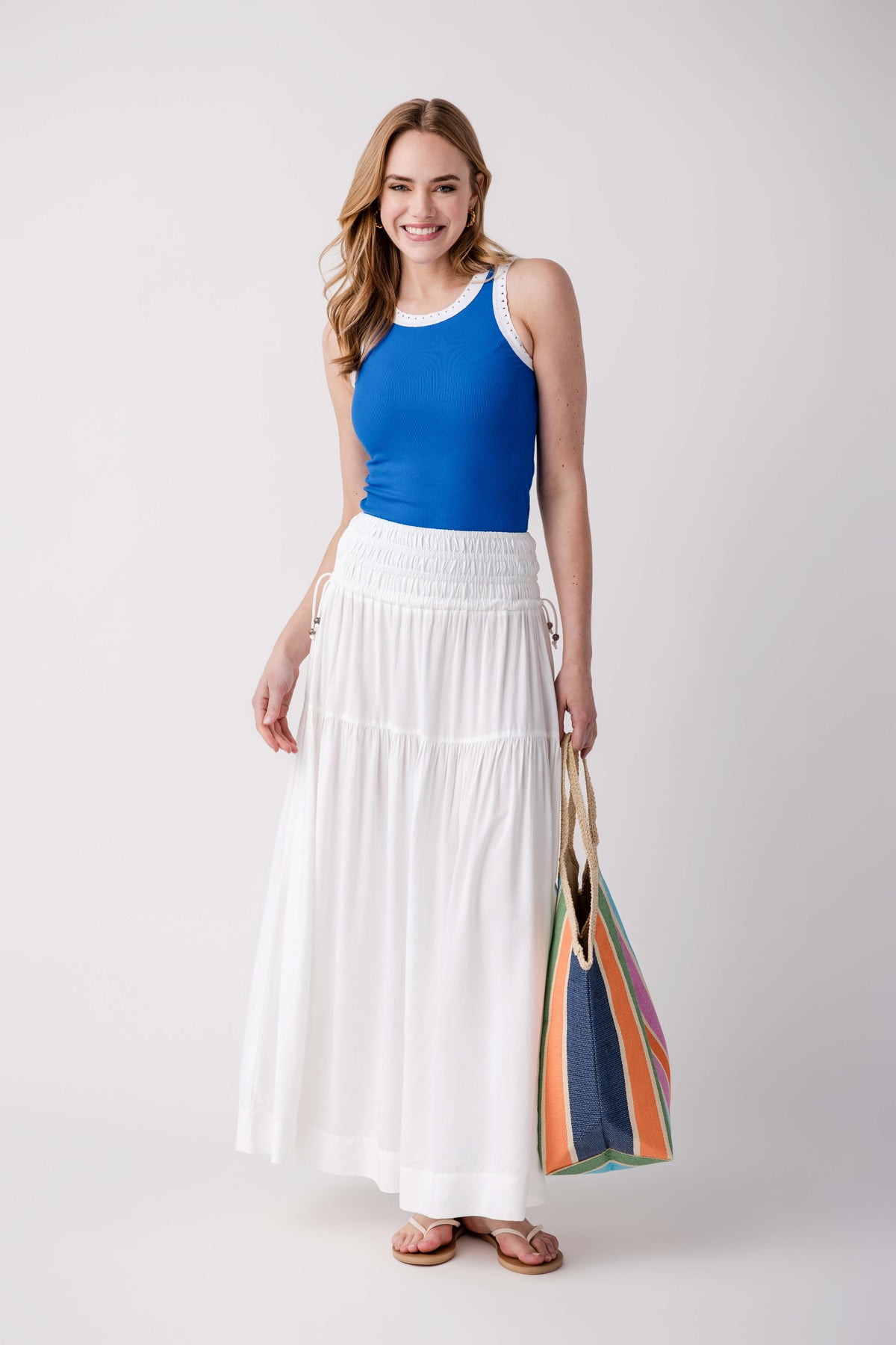 Blue sleeveless ribbed tank with scoop neck and eyelet-trim neckline