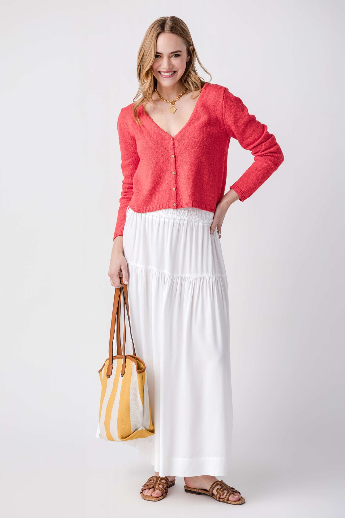 Tomato red V-neck cardigan with button front, long sleeves, and relaxed fit