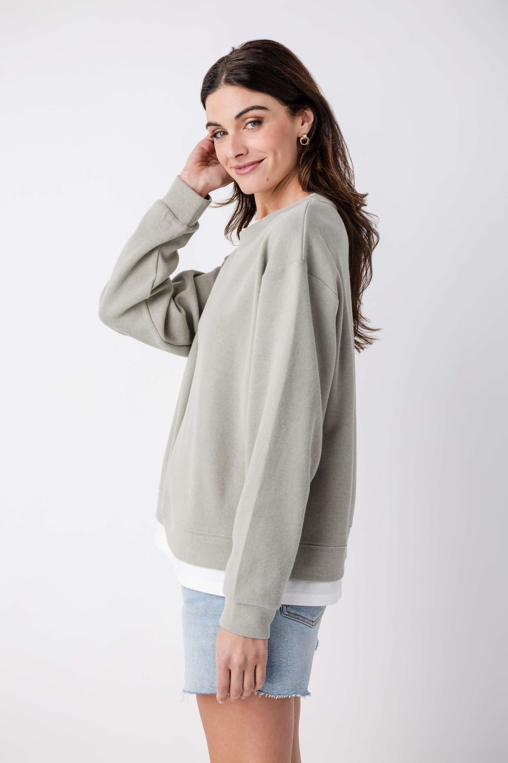 Olive-gray crewneck pullover, long sleeves with ribbed cuffs and hem, angled view