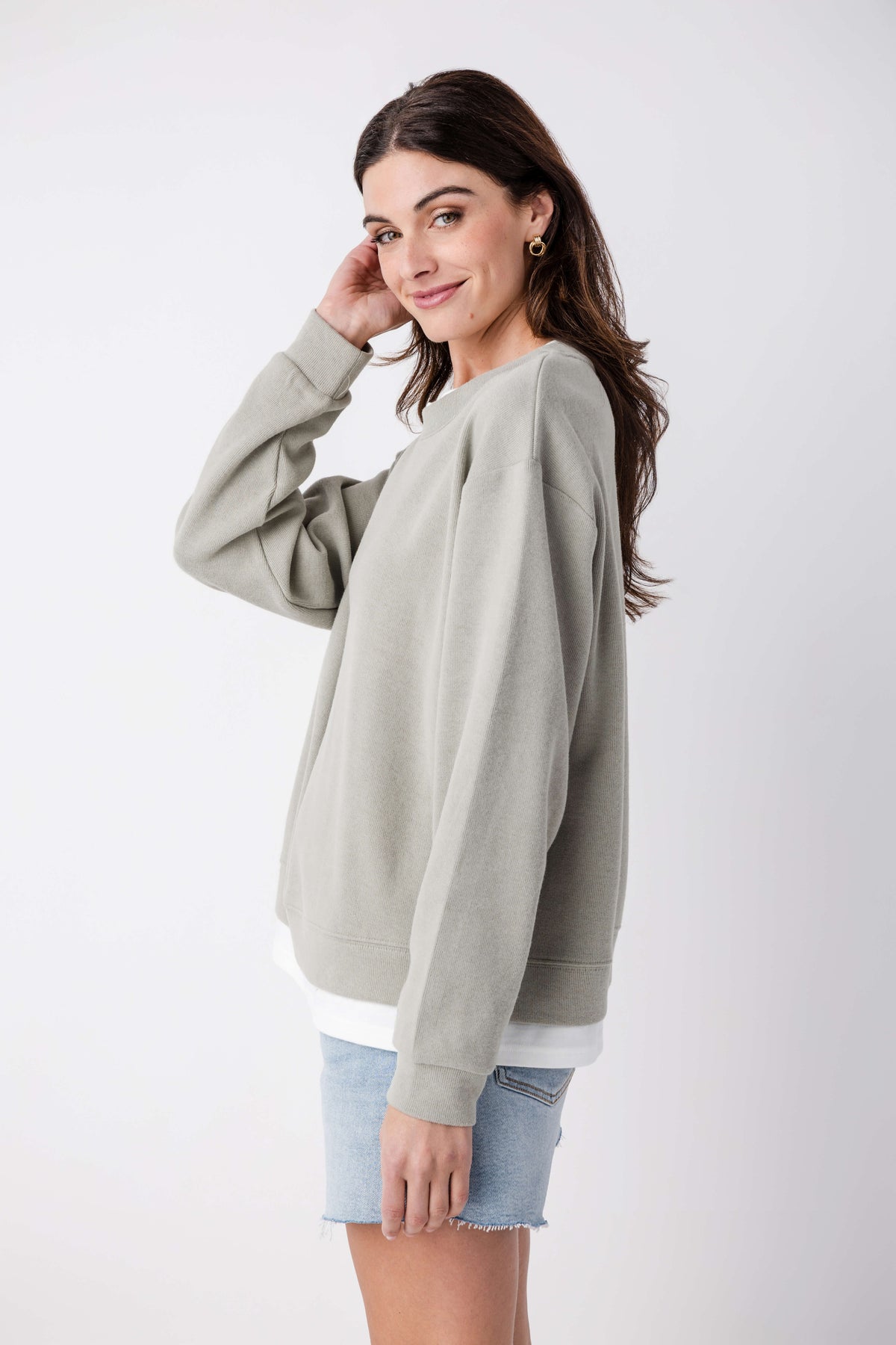 Olive-gray crewneck pullover, long sleeves with ribbed cuffs and hem, angled view