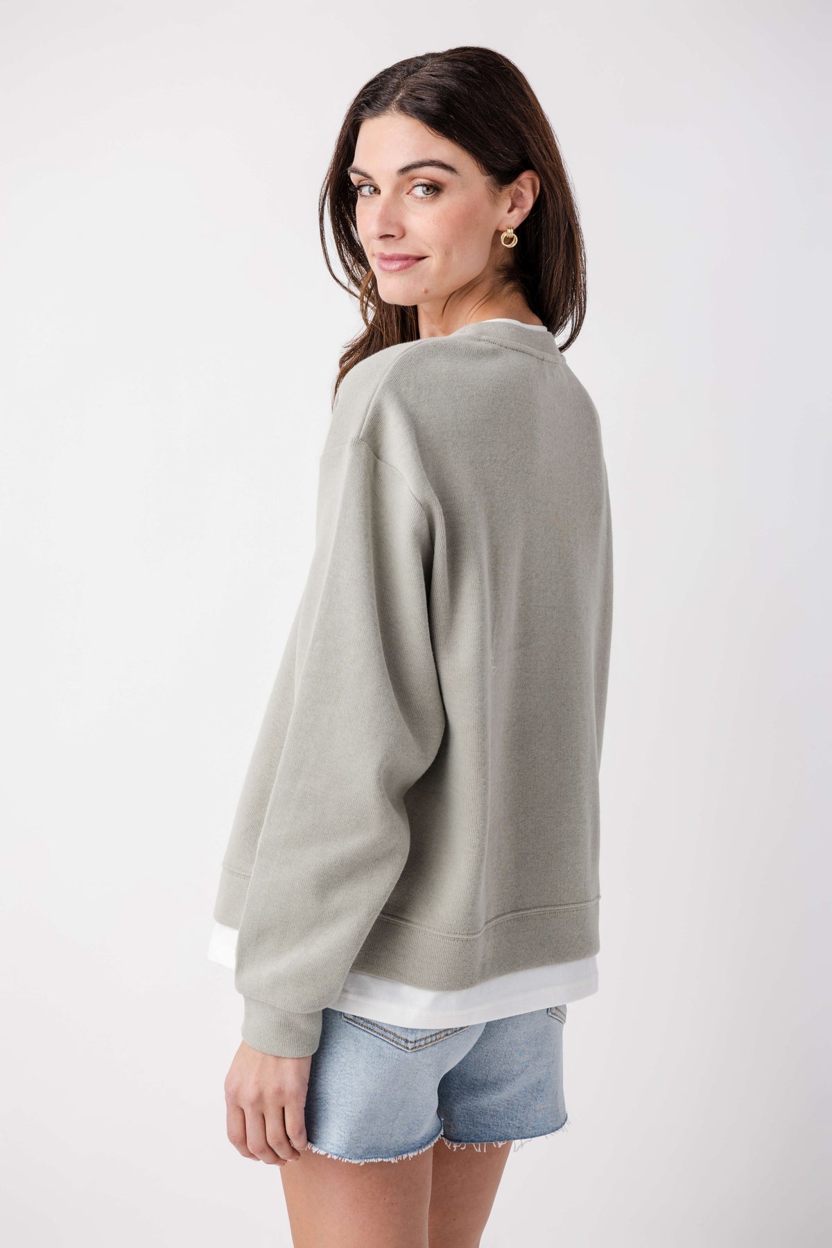 Olive-gray crewneck pullover, back view, long sleeves and ribbed cuffs
