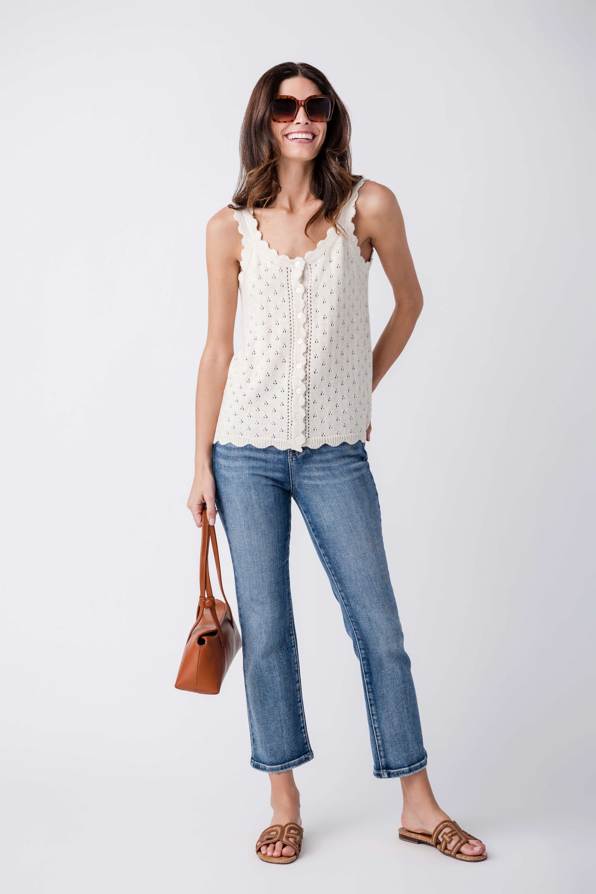 Medium wash straight-leg jeans with stitched seams and five-pocket front, cropped.