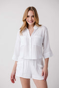 White button-front shirt with chest pockets, three-quarter sleeves, and a tiered-look waist