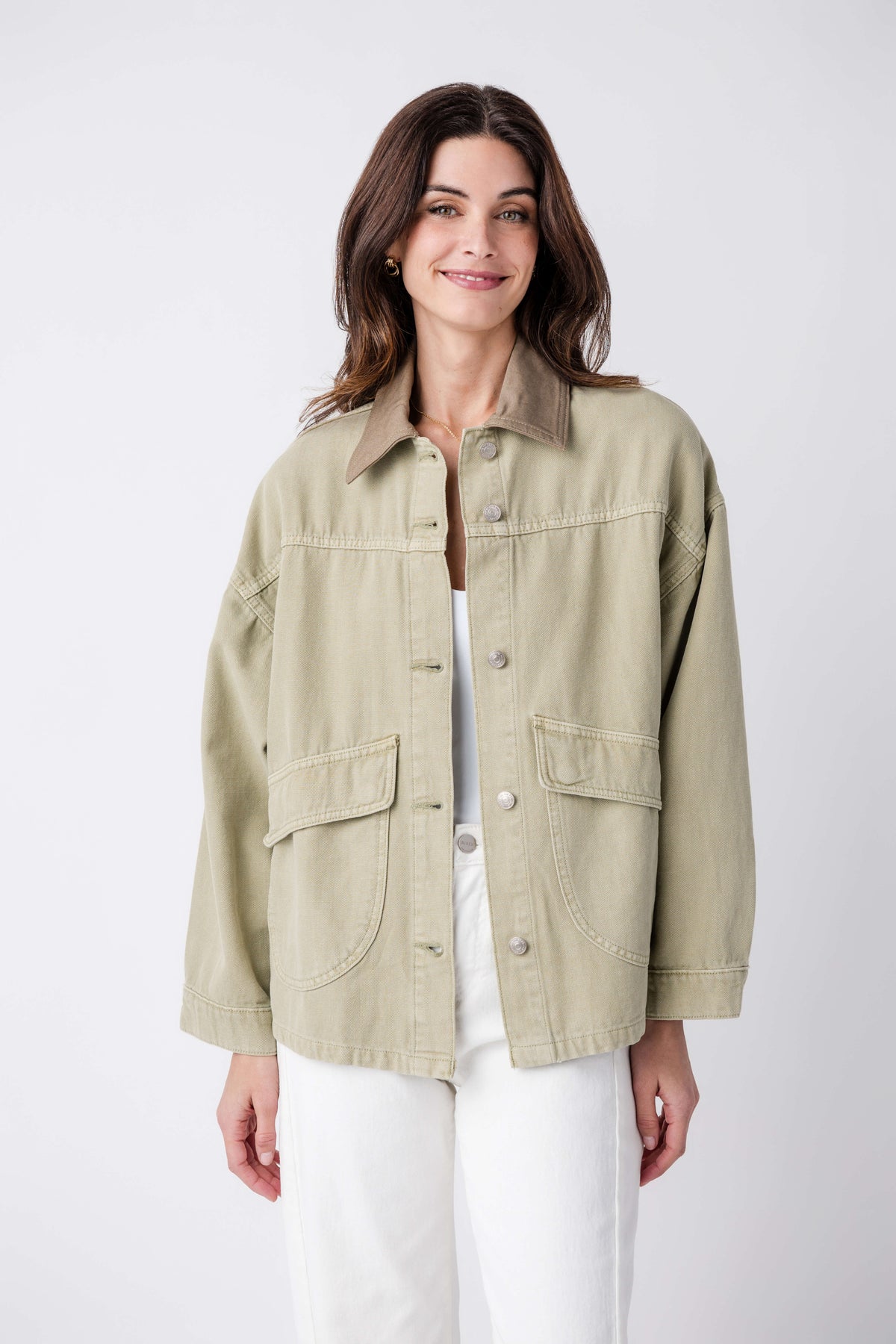 Washed sage denim jacket with two chest flap pockets and button front
