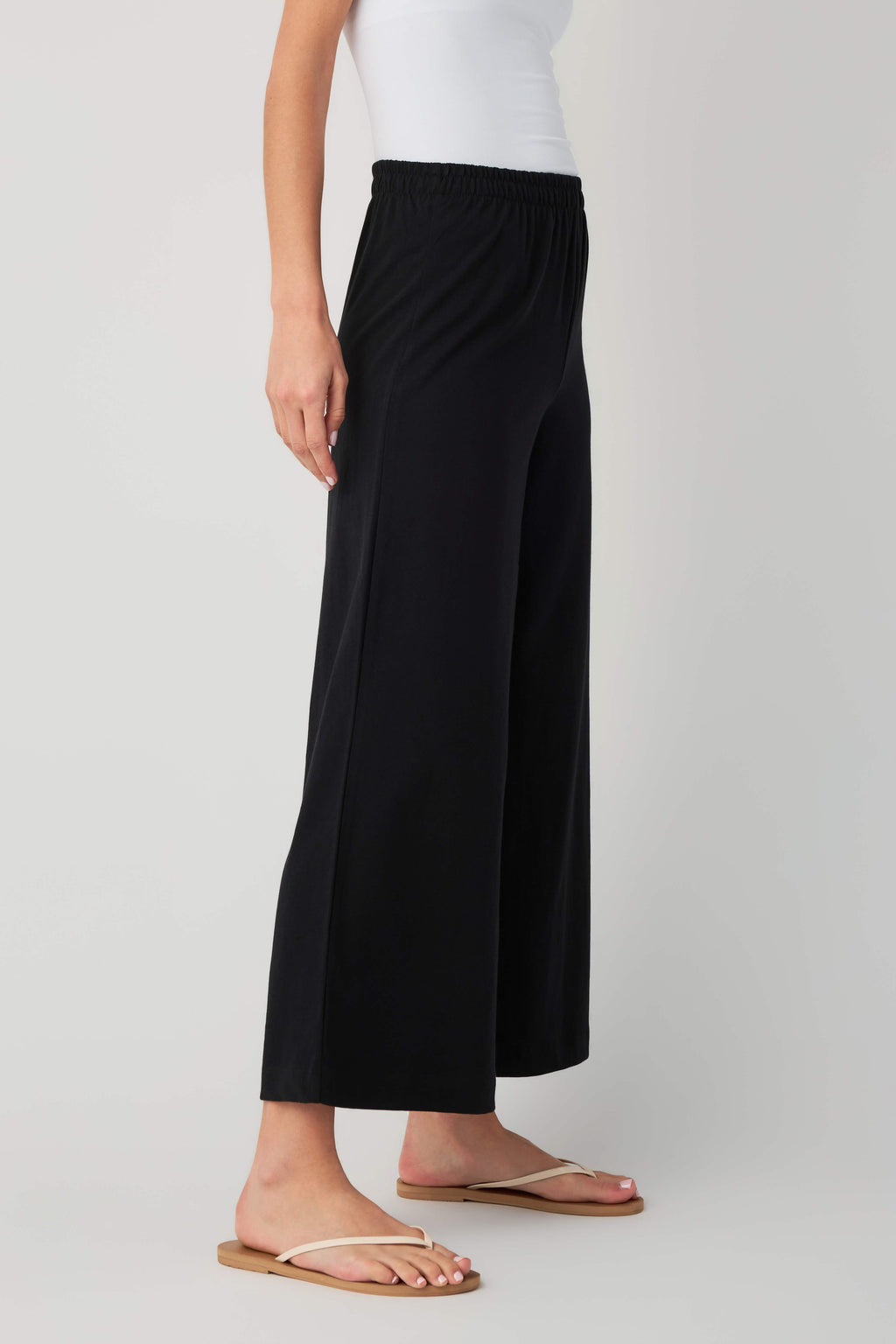 Jersey crop flare pants in true black, elastic waist, wide-leg crop silhouette.