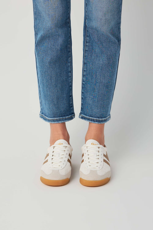 Off-white and tan low-top sneakers with lace-up front and gum rubber sole