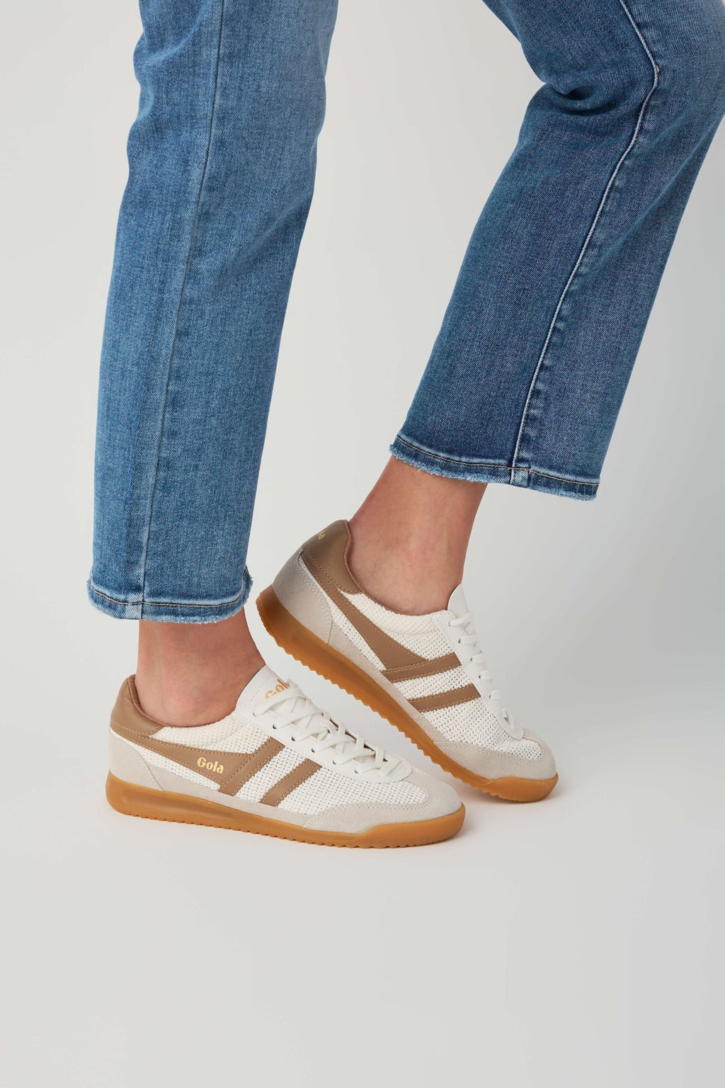 Off-white and tan low-top sneaker with visible side stripes and gum rubber sole