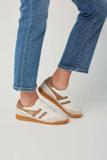 Off-white and tan low-top sneaker with visible side stripes and gum rubber sole