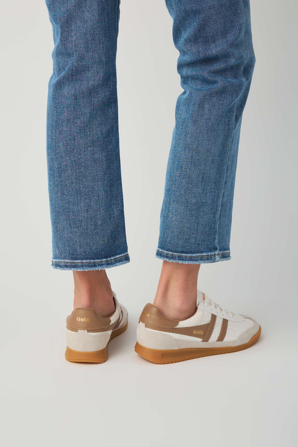 Off-white and tan low-top sneakers, rear view with lace-up design and gum sole
