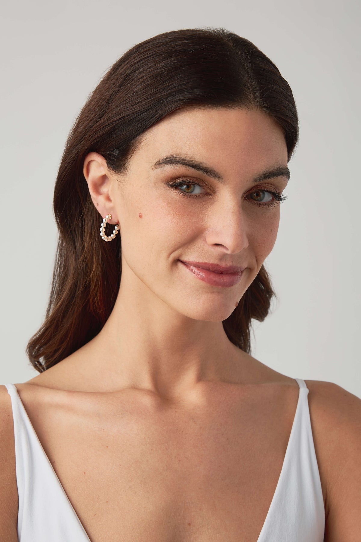 Gold hoop earrings with small dangling beaded charms