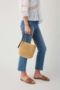 Natural woven shoulder bag with brown leather trim and short top handle