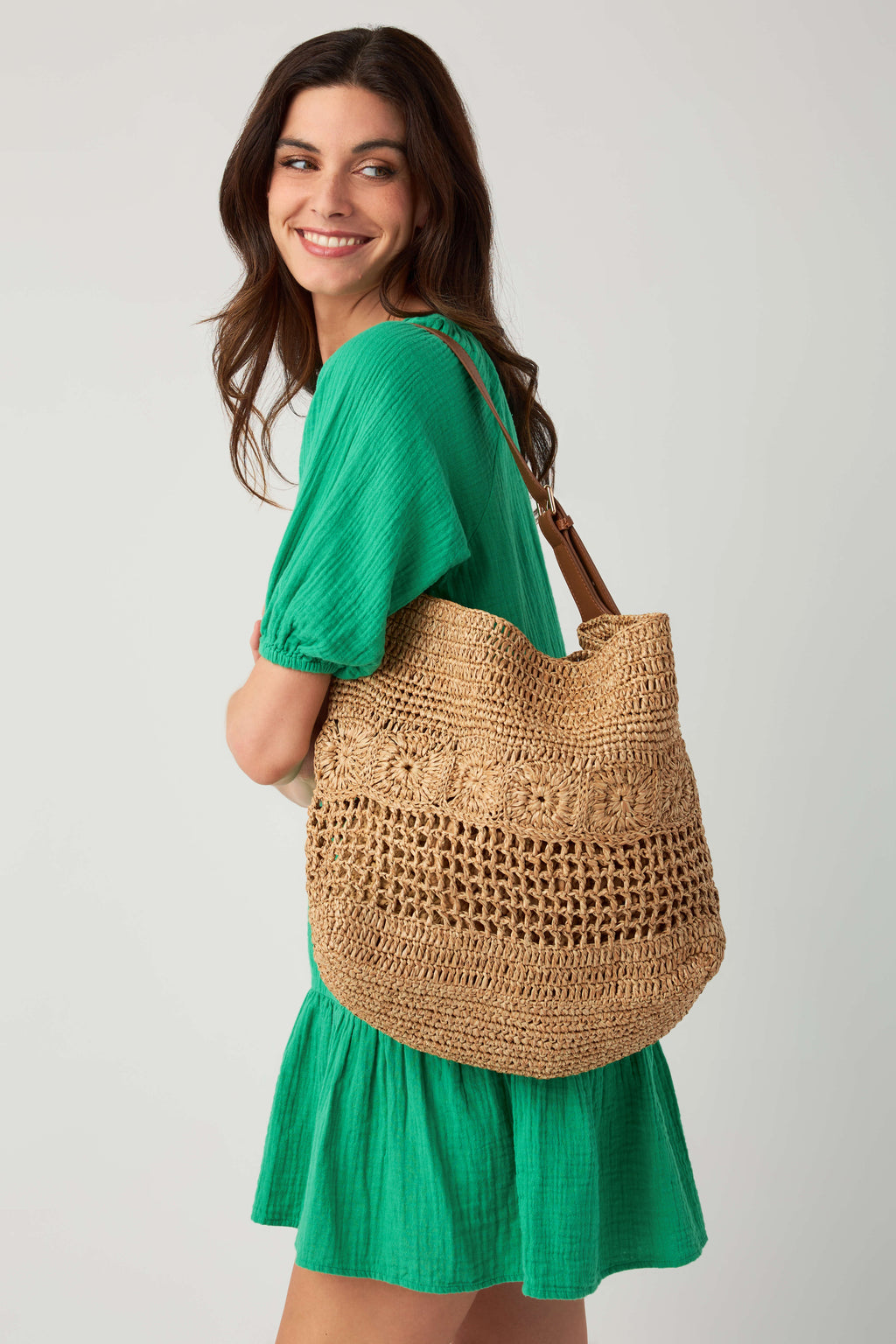 Natural woven hobo bag with rounded silhouette and shoulder strap