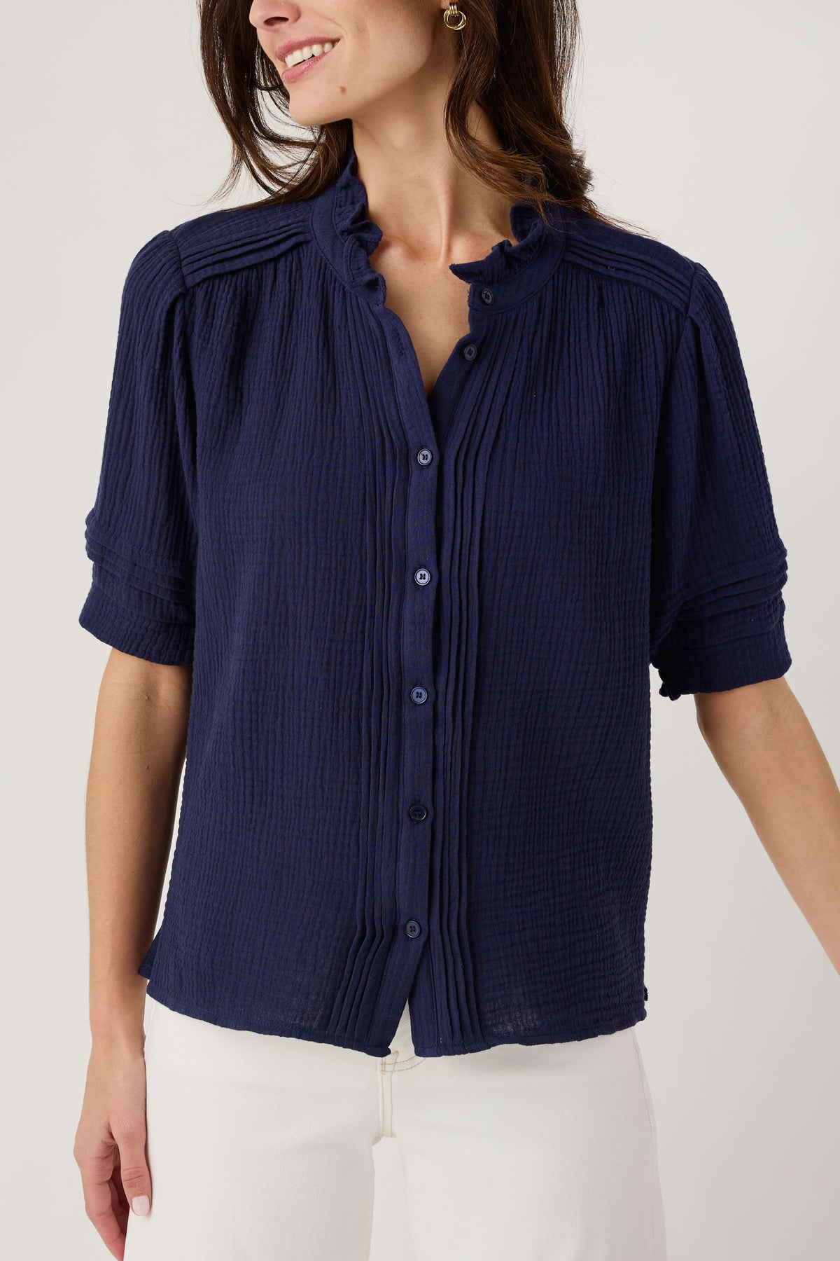 Navy gauze short sleeve top with button front, ruffled collar, and soft texture