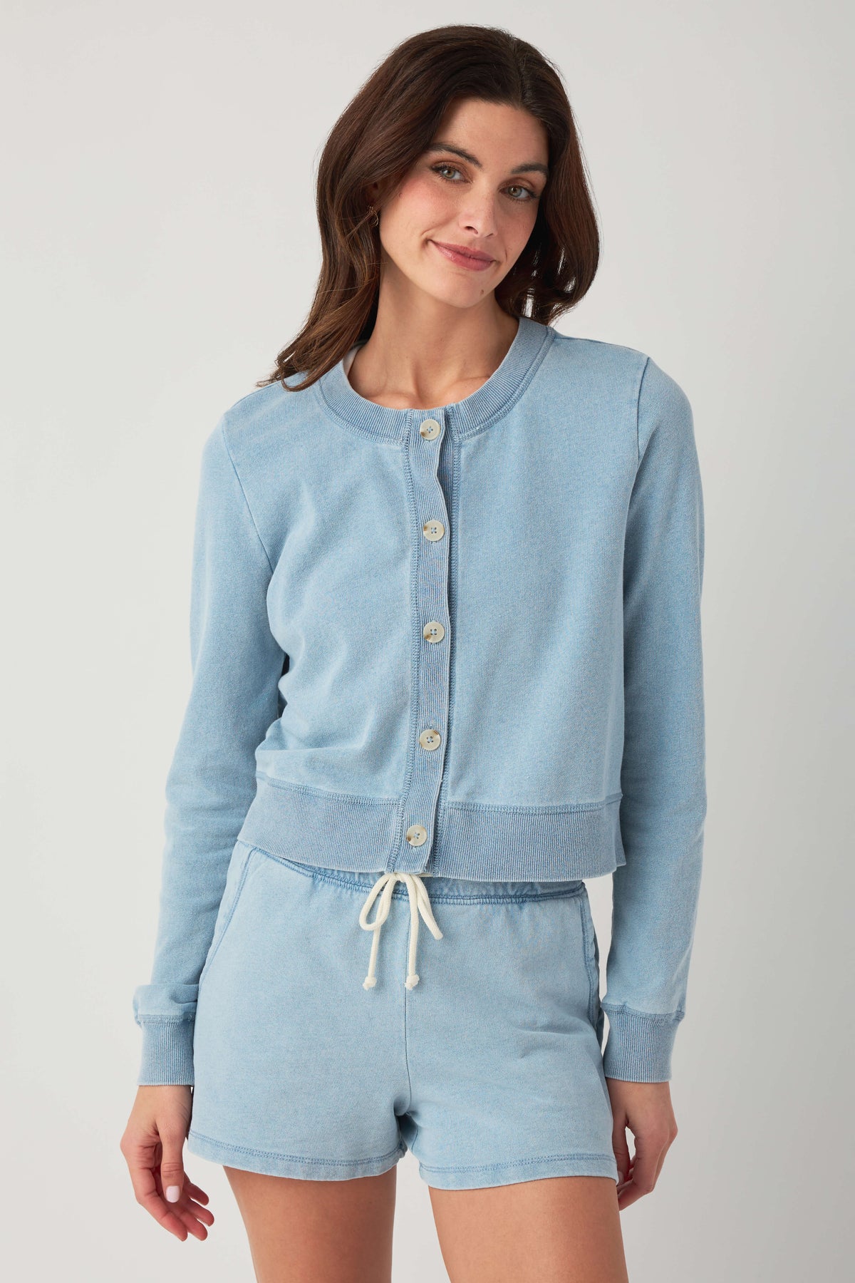 Light blue denim knit cardigan with button placket and ribbed trim, front view