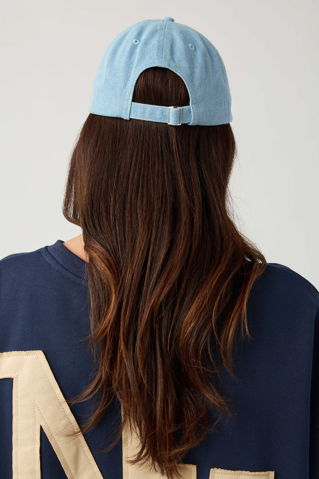 Back view denim blue baseball cap with adjustable strapback