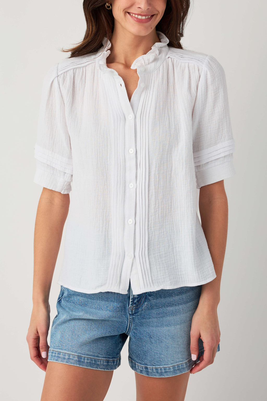 White gauze short-sleeve blouse with button front and ruffle collar.