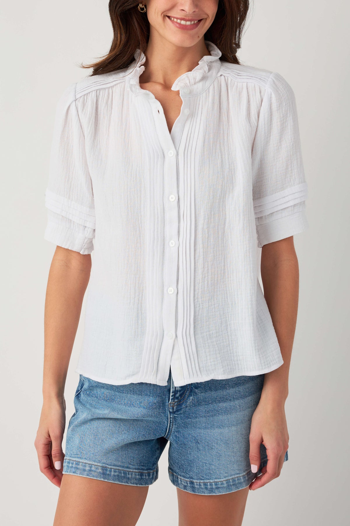 White gauze short-sleeve blouse with button front and ruffle collar.