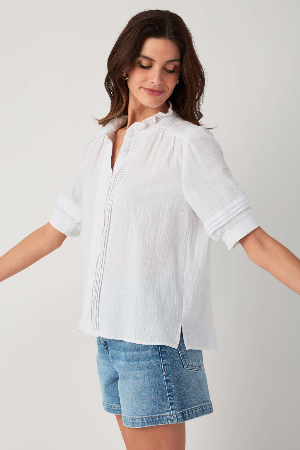 White gauze short-sleeve button blouse with high neckline and subtle vertical texture.