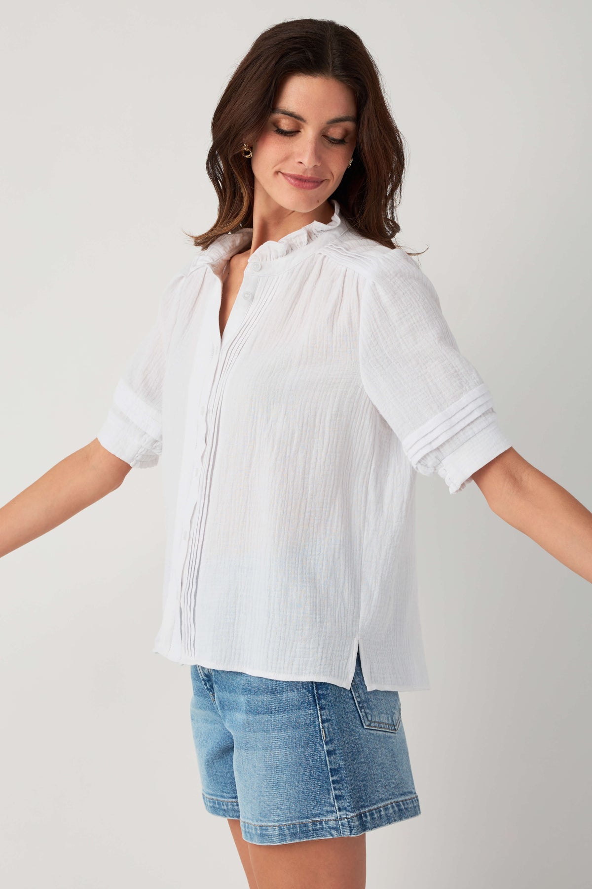 White gauze short-sleeve button blouse with high neckline and subtle vertical texture.