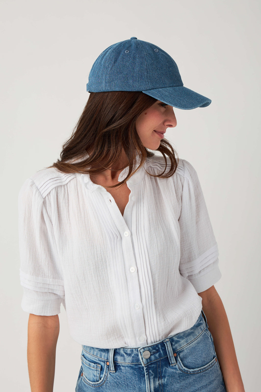 Blue baseball cap with curved brim and small top button detail