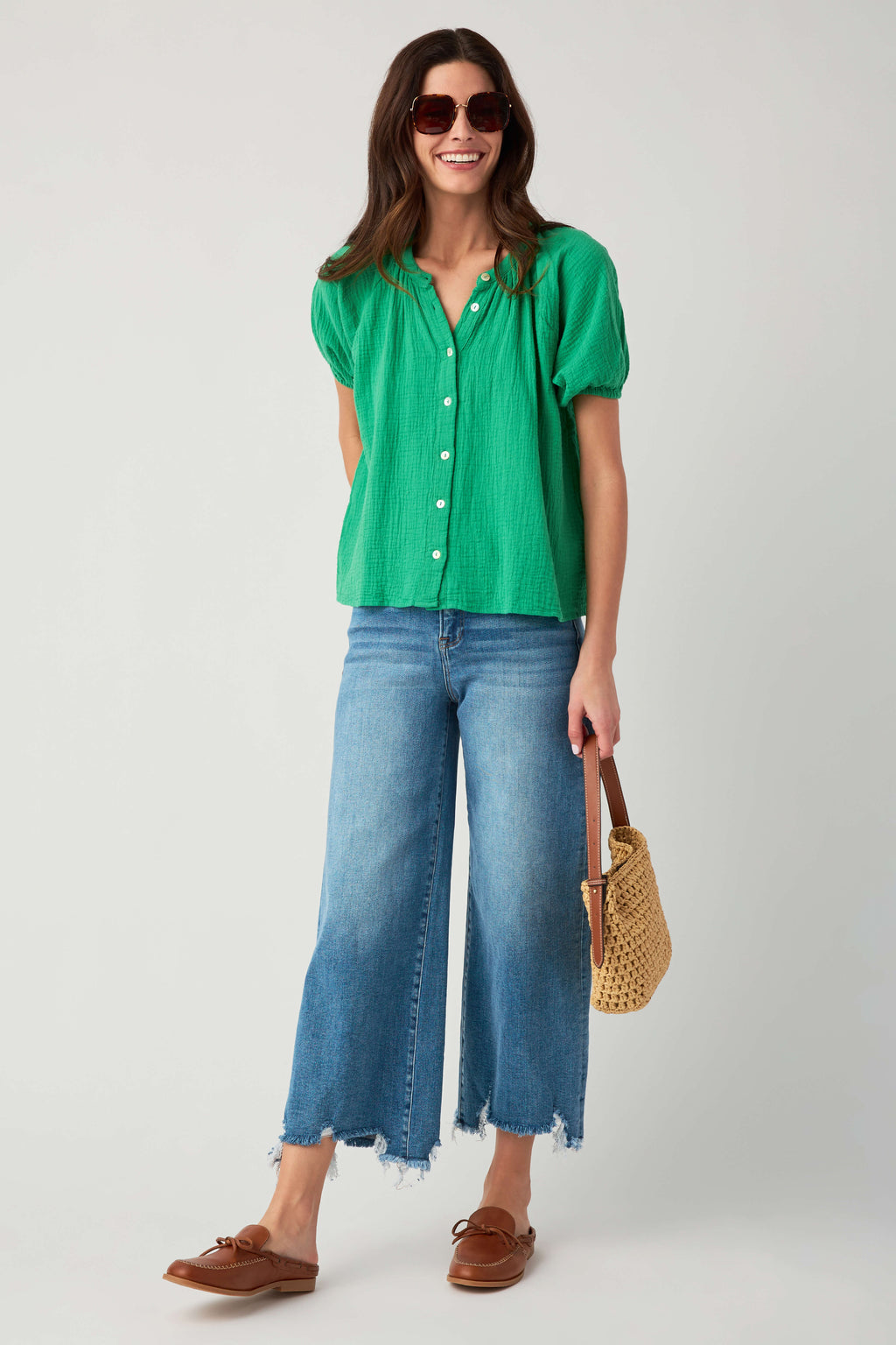 Kelly green gauze button-up top with short puff sleeves, styled with light jeans