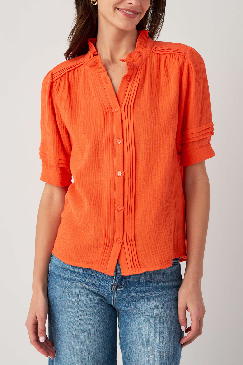 Coral gauze short sleeve top with split neckline, button front, and ruffled collar
