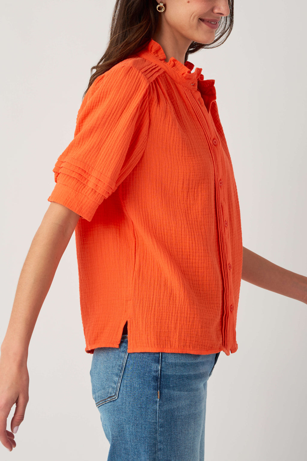 Orange gauze short sleeve top, side view: button front and gathered ruffle collar
