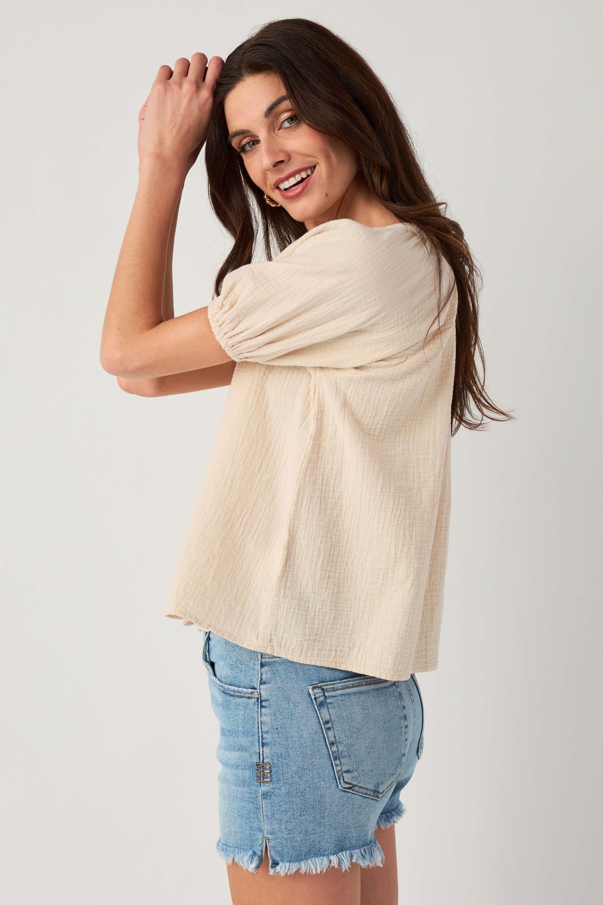 Natural gauze button-up top, side view with puff sleeves and button front