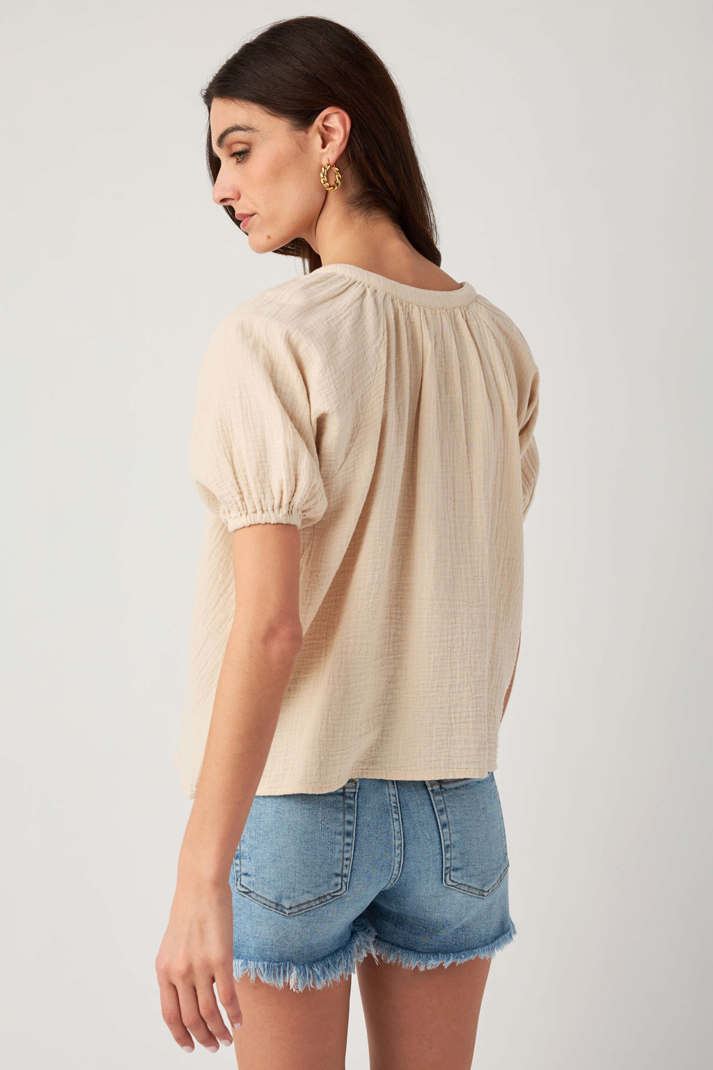 Natural gauze button-up top back view with elastic gathered puff sleeves detail