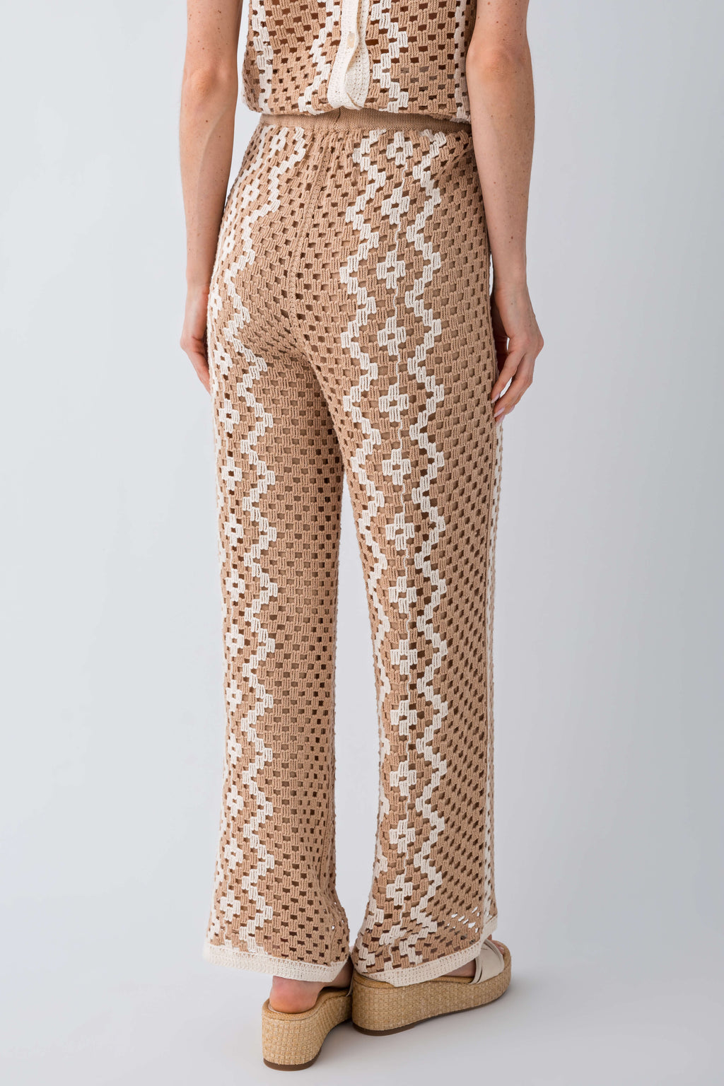 Natural crochet pants detail view: vertical zigzag motifs and straight wide leg