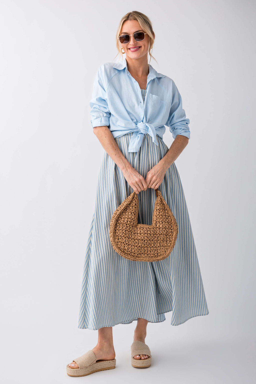 Natural raffia platform slides on model feet, low platform espadrille sole
