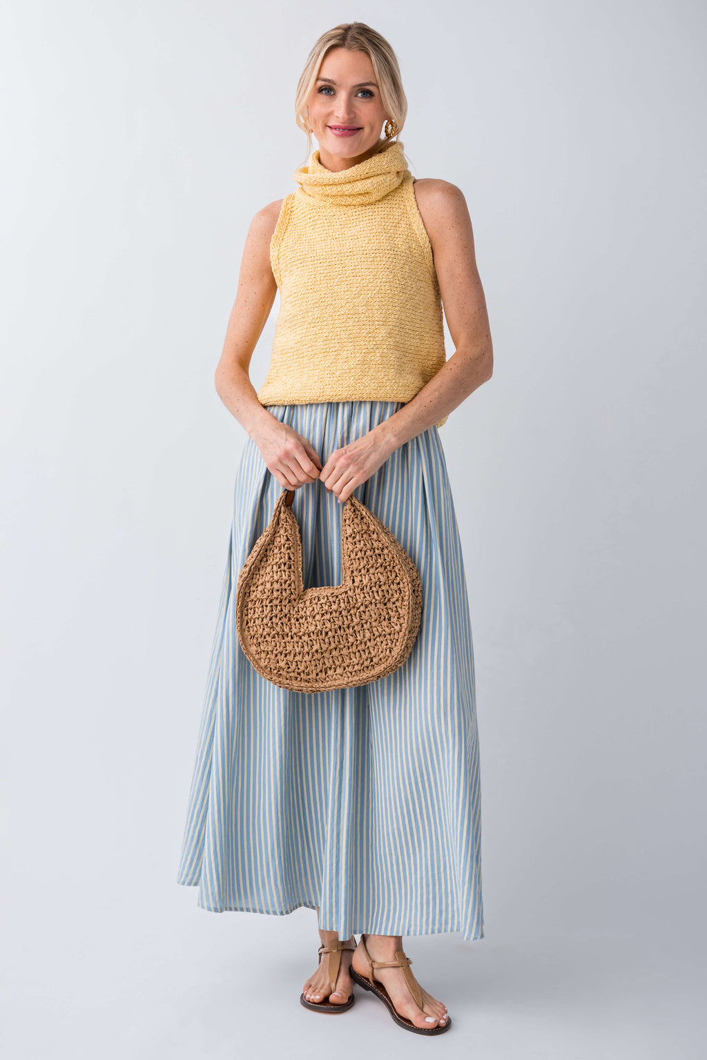 Yellow sleeveless knit turtleneck top with textured knit and high neckline