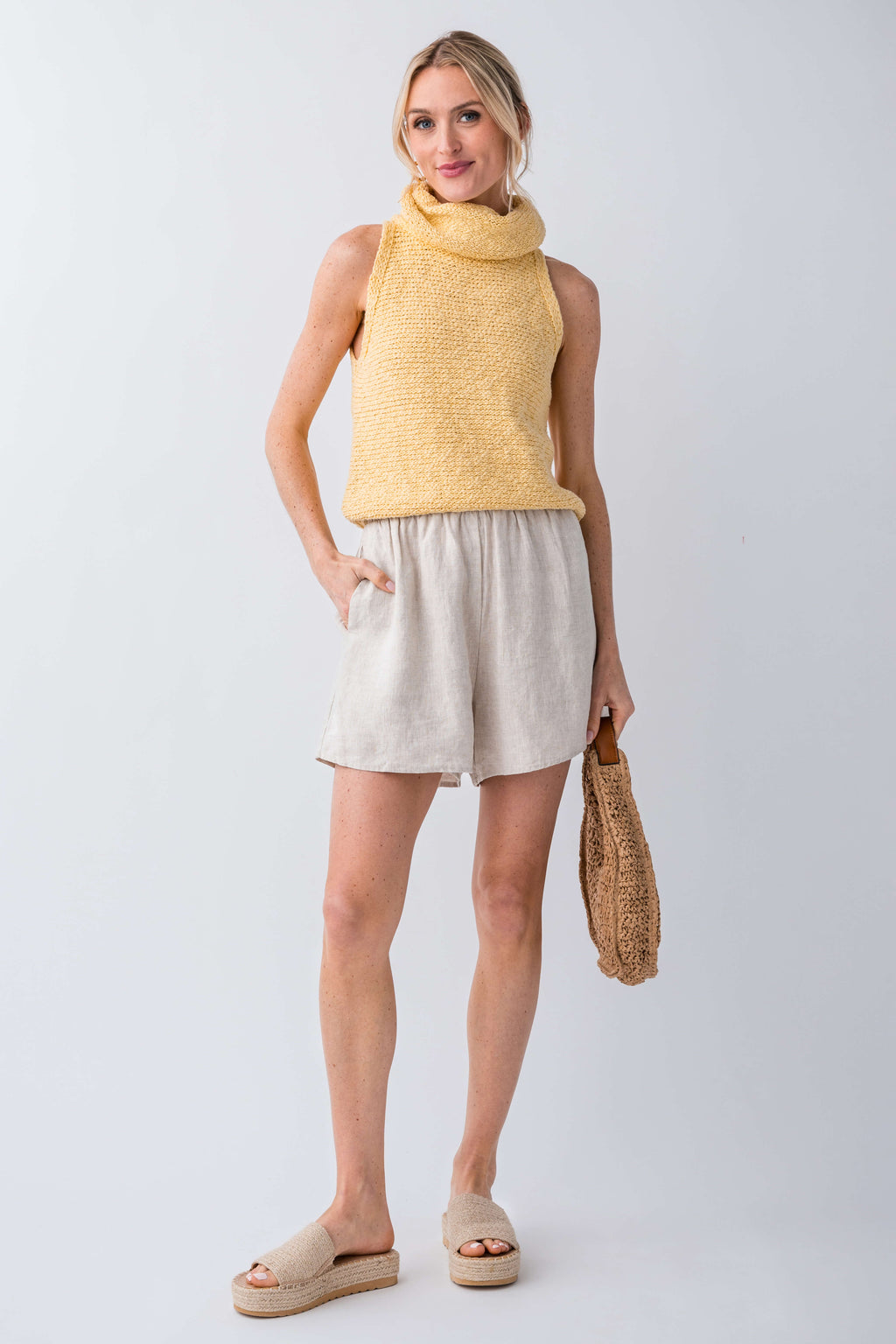 Yellow sleeveless knit turtleneck top with textured knit and relaxed hemline
