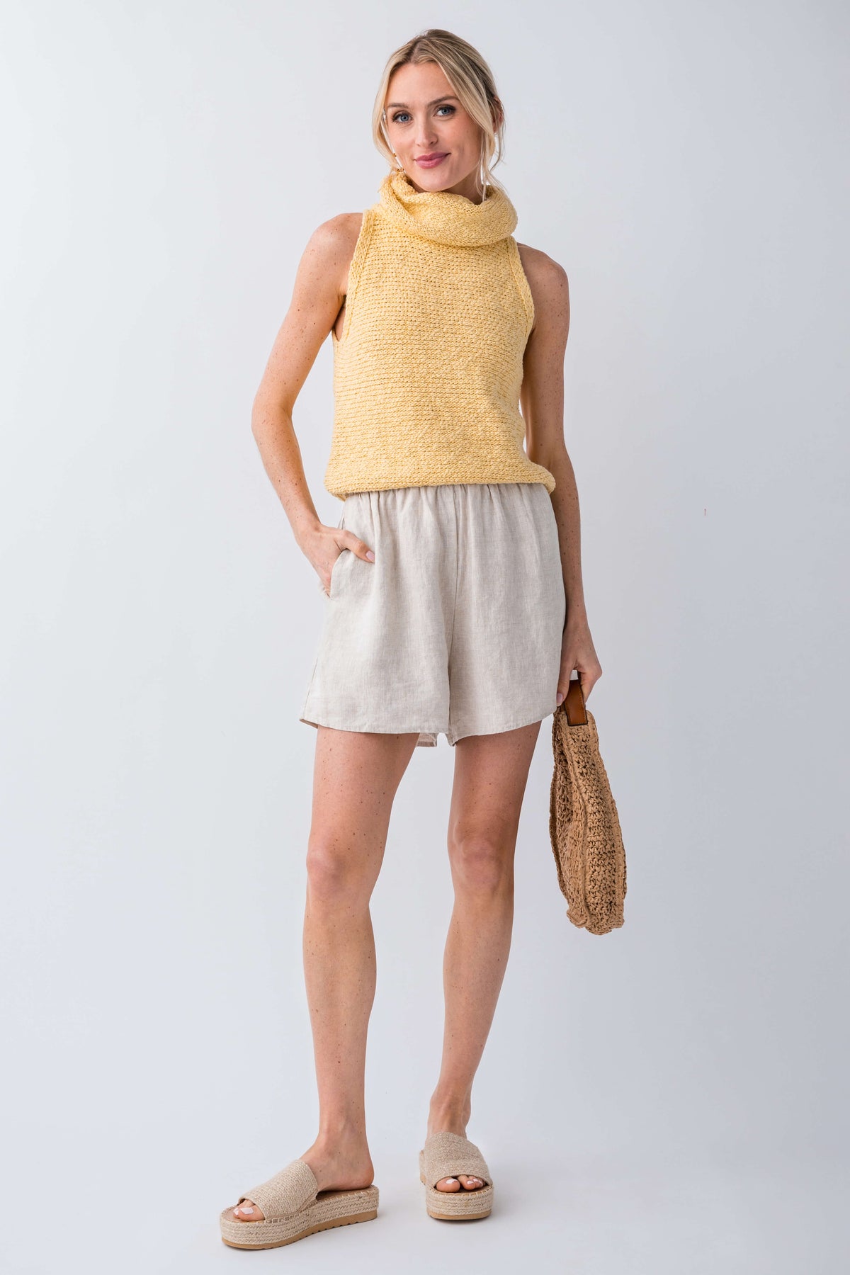 Yellow sleeveless knit turtleneck top with textured knit and relaxed hemline